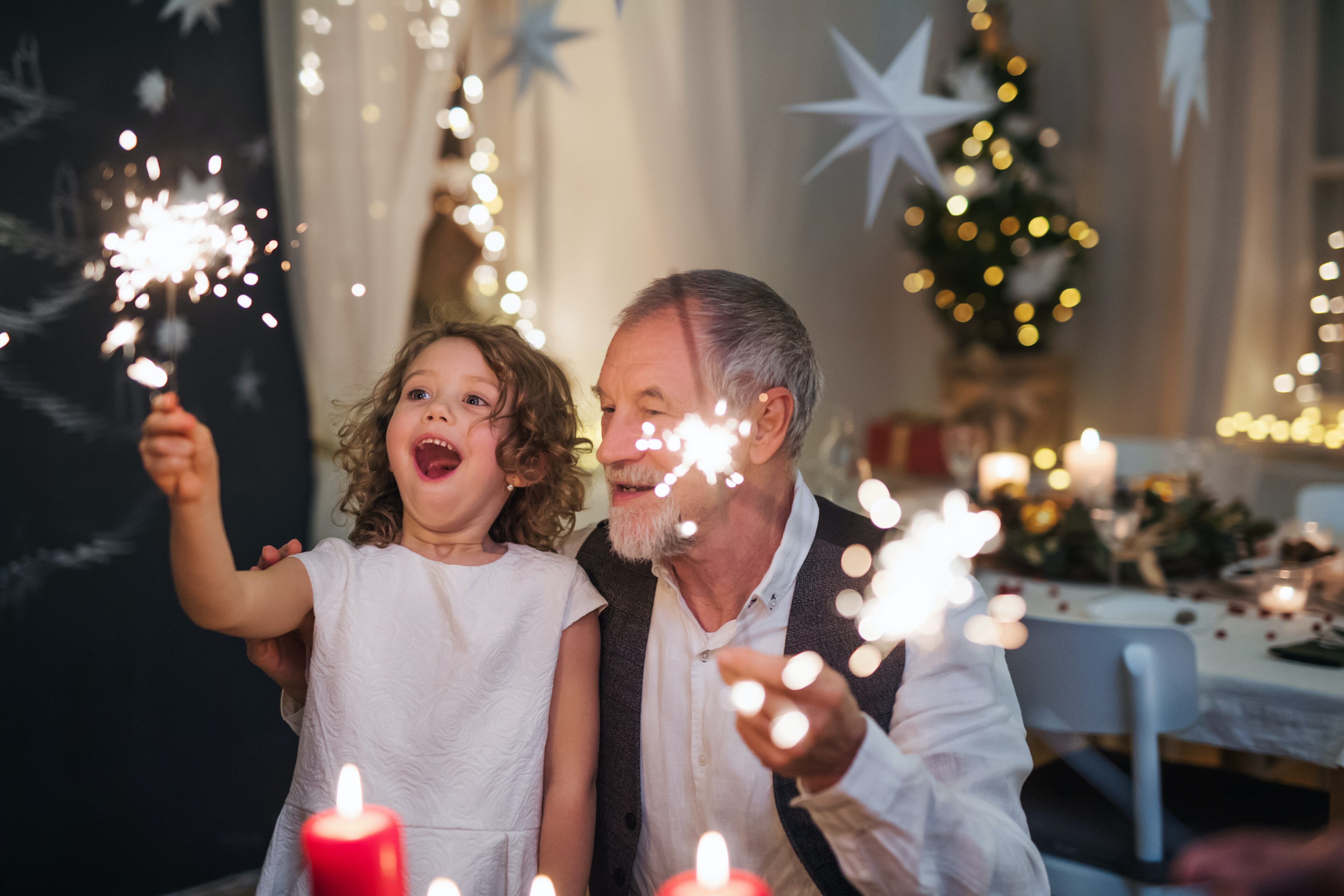 grandfather with granddaughter and sparklers
